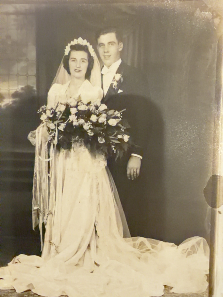 Wedding portrait of Viola and Frank Samuel with a bridal bouquet.