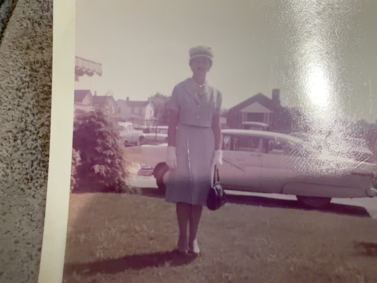 Viola Samuel wearing a hat and holding a handbag outdoors.