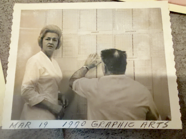 Indoor photograph of Viola Samuel and another person, with a handwritten note along the print border.