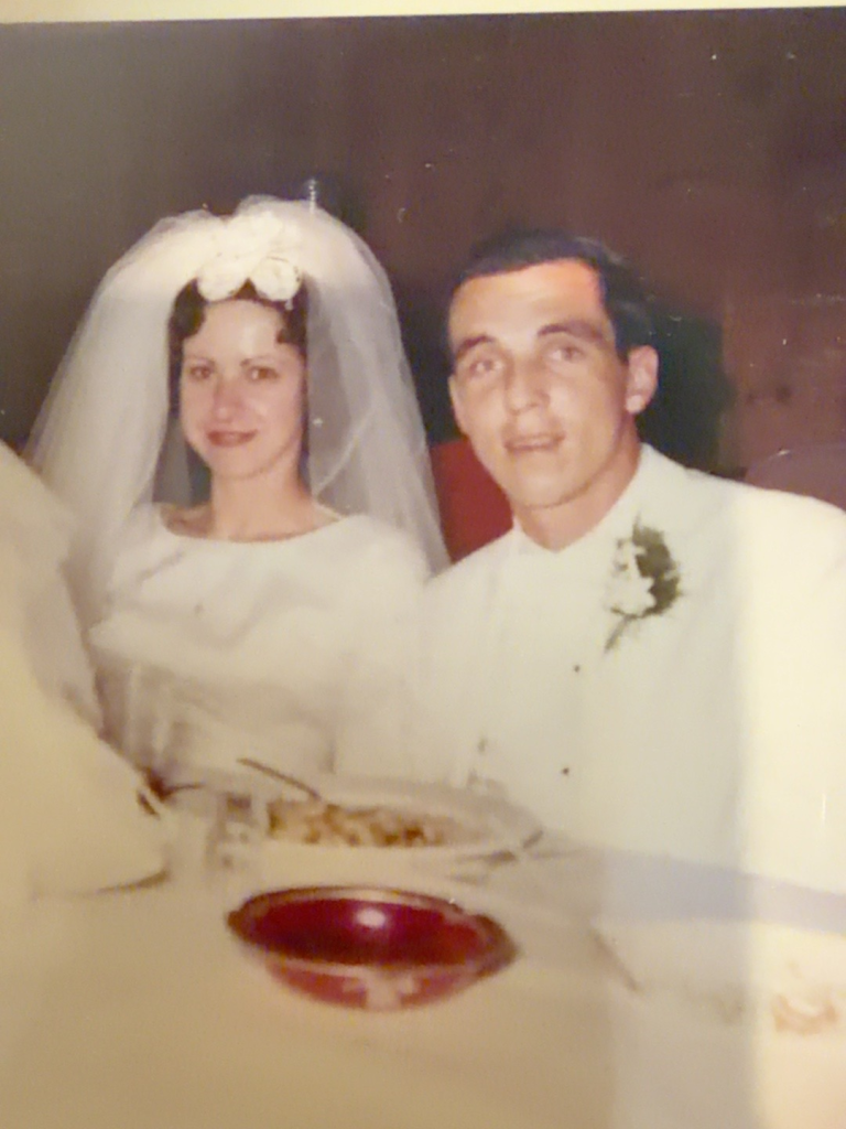 Carol Rudy Samuel and Bob Samuel seated together at their wedding.