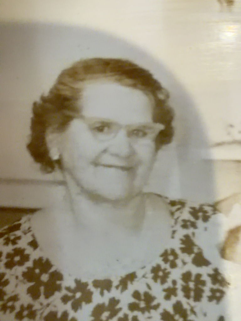 Portrait of Frances Okulewicz Rudy wearing glasses and a patterned blouse.