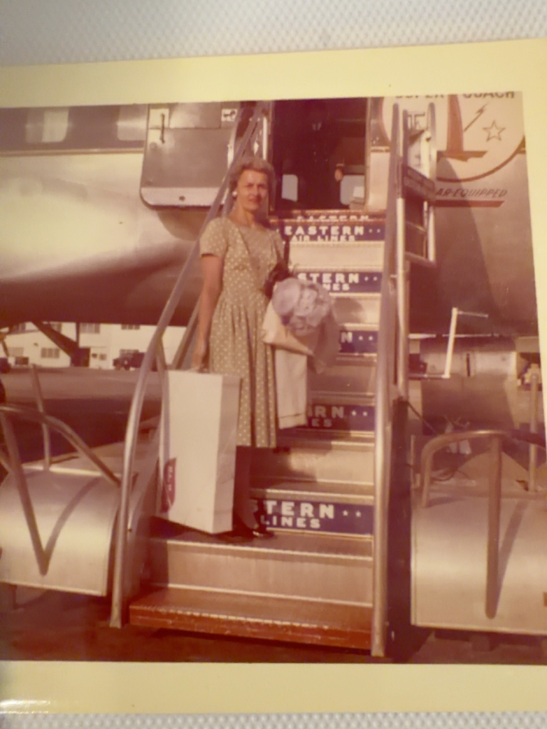 Viola Samuel standing on airplane boarding steps.